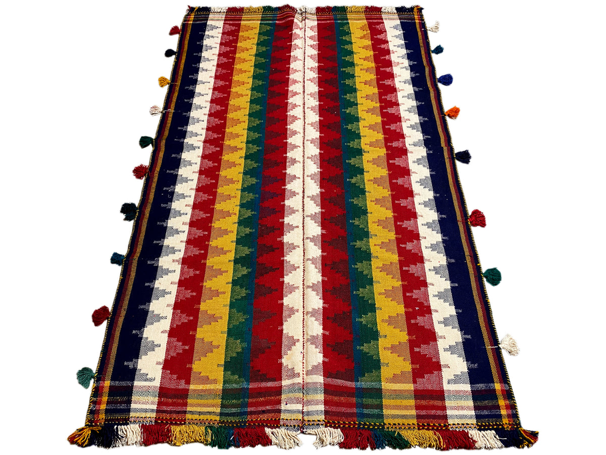 Tappeto Jajim in tessuto: design a righe con pon-pon e bordo sfrangiato