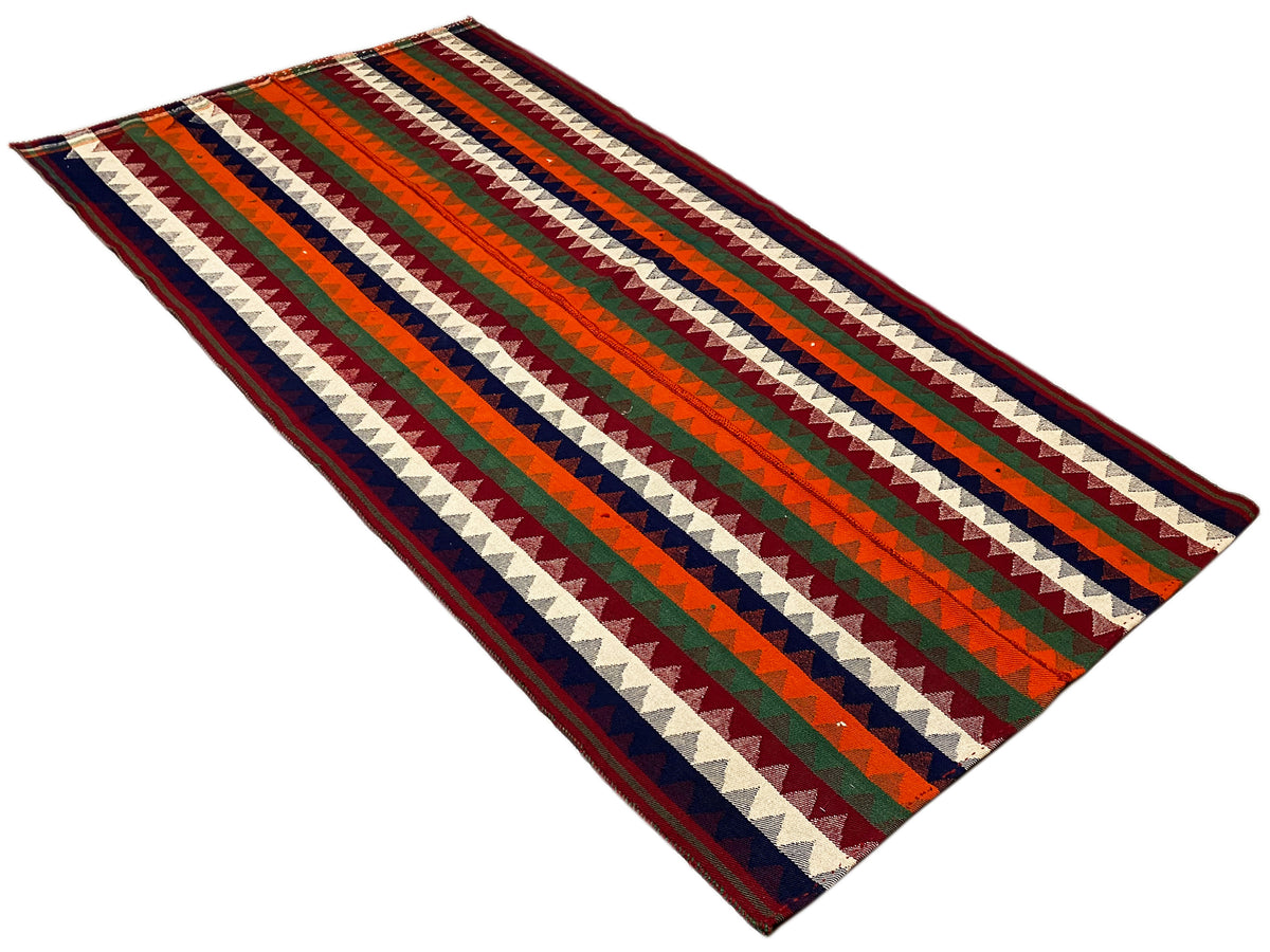 Tappeto Jajim piegato obliquamente: ampie bande a zigzag e a righe, multicolore