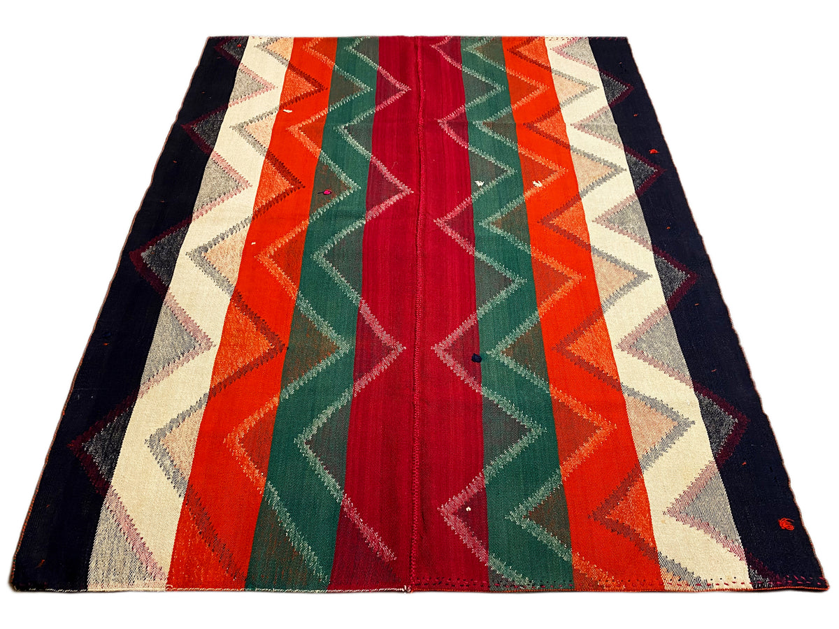 Tappeto con motivo geometrico a zigzag e a strisce in rosso, verde, arancione e blu scuro