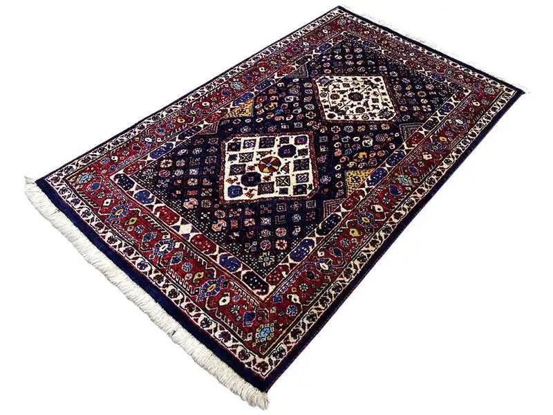 Tappeto blu scuro con bordo rosso, motivi quadrati e frange