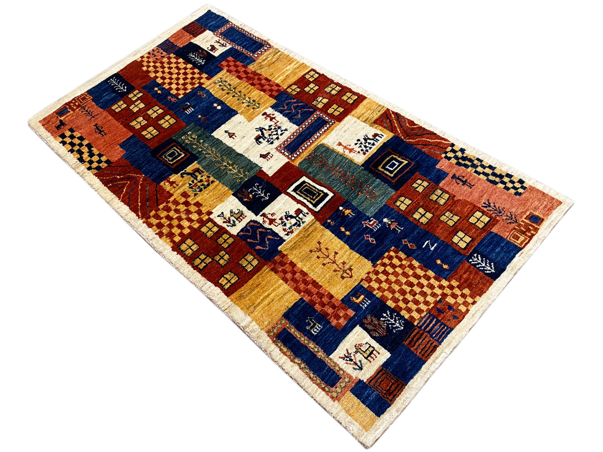 Gabbeh-Luri Teppich 158x86 cm, schräg gelegt: geometrische Motive in Blau, Rot und Gelb-Ocker