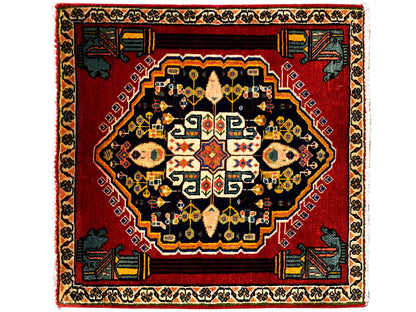 Tappeto Poshti con fondo rosso, medaglione scuro e motivi colorati al centro