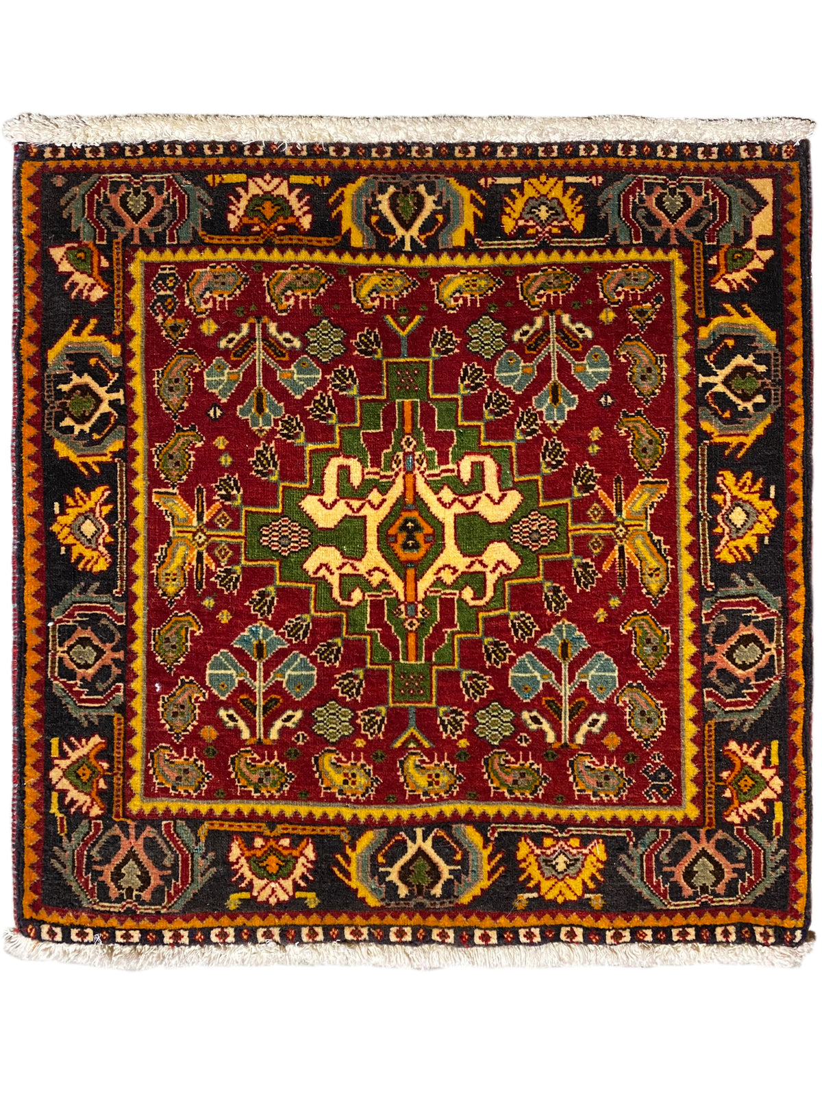 Tappeto Poshti 61x61 cm con ornamento multicolore e bordo con frange lungo il margine