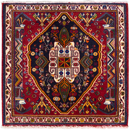 Tappeto Poshti (67×67 cm) con fondo scuro, bordura e medaglione geometrico