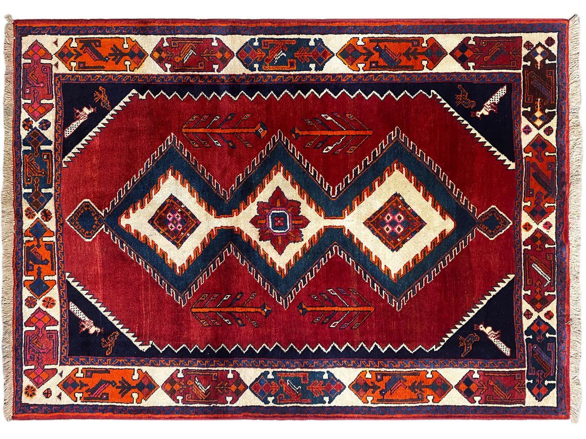Shiraz Qashqai-Teppich mit rotem Zickzack- und Rautenmuster, dunkelblauer Umrandung